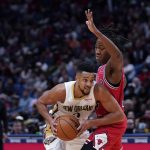 
              New Orleans Pelicans guard CJ McCollum drives to the basket against Chicago Bulls guard Ayo Dosunmu in the first half of an NBA basketball game in New Orleans, Thursday, March 24, 2022. (AP Photo/Gerald Herbert)
            