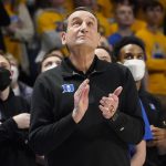 
              Duke coach Mike Krzyzewski applauds as he watches a video honoring him before the team's NCAA college basketball game against Pittsburgh, Tuesday, March 1, 2022, in Pittsburgh. Krzyzewski has announced his retirement at the end of the season. (AP Photo/Keith Srakocic)
            