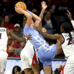 
              North Carolina guard Alyssa Ustby, center, looks to pass the ball while surrounded by Arizona defenders during a women's college basketball game in the NCAA tournament hosted in Tucson, Ariz., Monday, March 21, 2022. (Rebecca Sasnett/Arizona Daily Star via AP)
            