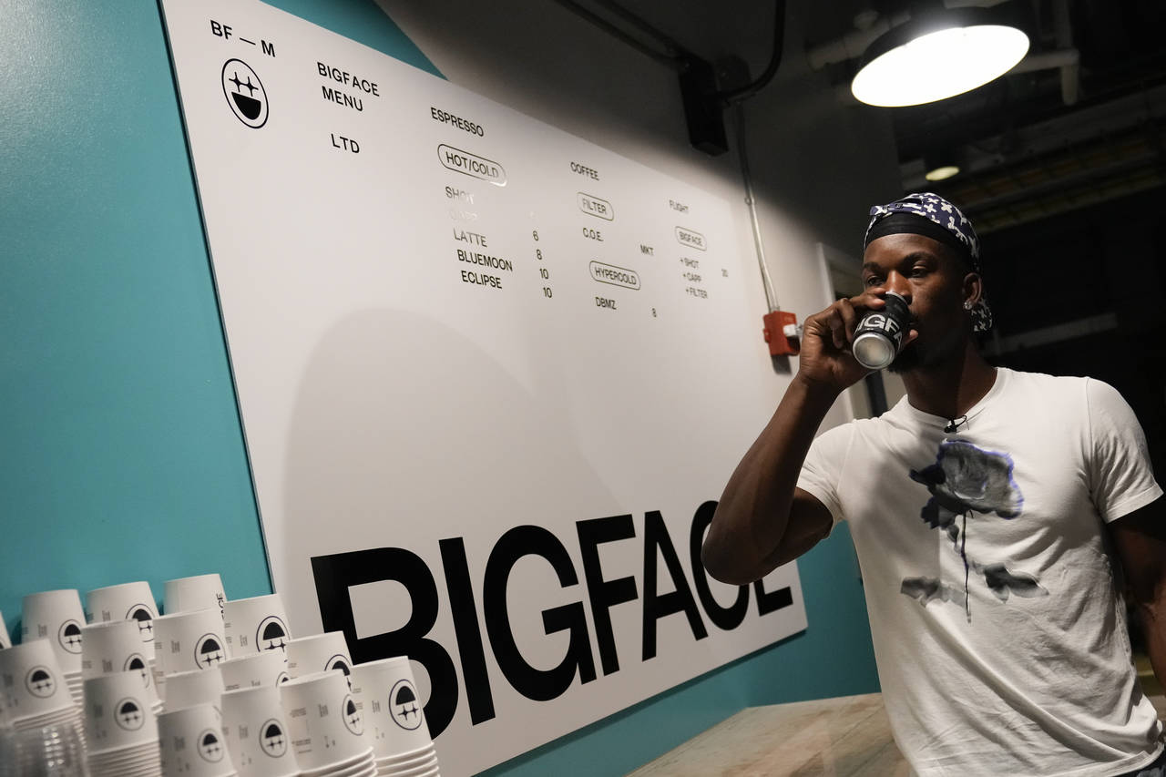 Miami Heat forward Jimmy Butler poses for a photo at a kiosk that will sell his BigFace brand of co...