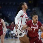 
              Alabama's Megan Abrams (1) tries to drive around Georgia's Jordan Isaacs (20) in the first half of an NCAA college basketball game at the women's Southeastern Conference tournament Thursday, March 3, 2022, in Nashville, Tenn. (AP Photo/Mark Humphrey)
            