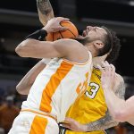 
              Tennessee's Uros Plavsic (33) is fouled by Michigan's Brandon Johns Jr., right, during the first half of a college basketball game in the second round of the NCAA tournament, Saturday, March 19, 2022, in Indianapolis. (AP Photo/Darron Cummings)
            