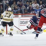 
              Boston Bruins' Brad Marchand (63) scores on Winnipeg Jets goaltender Connor Hellebuyck (37) during the second period of an NHL hockey game Friday, March 18, 2022 in Winnipeg, Manitoba.(John Woods/The Canadian Press via AP)
            