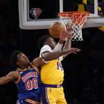 
              Golden State Warriors forward Jonathan Kuminga (00) and Los Angeles Lakers forward Stanley Johnson (14) go up for a rebound during the first half of an NBA basketball game in Los Angeles, Saturday, March 5, 2022. (AP Photo/Ashley Landis)
            