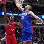 
              Chicago Bulls guard Ayo Dosunmu, left, shoots against Los Angeles Clippers forward Nicolas Batum during the first half of an NBA basketball game in Chicago, Thursday, March 31, 2022. (AP Photo/Nam Y. Huh)
            