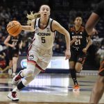 
              Connecticut's Paige Bueckers (5) drives to the basket during the first half of a first-round women's college basketball game against Mercer in the NCAA tournament, Saturday, March 19, 2022, in Storrs, Conn. (AP Photo/Jessica Hill)
            
