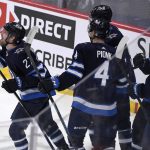 
              Winnipeg Jets' Nikolaj Ehlers (27) celebrates his goal against the New York Rangers with teammates during the second period of an NHL hockey game, in Winnipeg, Manitoba, Sunday, March 6, 2022. (Fred Greenslade/The Canadian Press via AP)
            