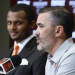 
              Cleveland Browns head coach Kevin Stefanski answers a question as new quarterback Deshaun Watson looks on during a news conference at the NFL football team's training facility, Friday, March 25, 2022, in Berea, Ohio. (AP Photo/Ron Schwane)
            