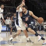 
              Memphis Grizzlies' Tyus Jones, right, gets past Orlando Magic's Cole Anthony (50) in the first half of an NBA basketball game Saturday, March 5, 2022, in Memphis, Tenn. (AP Photo/Karen Pulfer Focht)
            