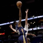 
              New Orleans Pelicans forward Tony Snell (21) shoots over Orlando Magic forward Franz Wagner during the first quarter of an NBA basketball game in New Orleans, Wednesday, March 9, 2022. (AP Photo/Derick Hingle)
            