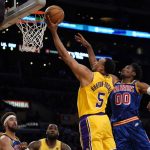 
              Los Angeles Lakers guard Talen Horton-Tucker (5) shoots against Golden State Warriors forward Jonathan Kuminga (00) during the first half of an NBA basketball game in Los Angeles, Saturday, March 5, 2022. (AP Photo/Ashley Landis)
            