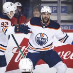 
              Edmonton Oilers' Derick Brassard, right, celebrates his goal against the Calgary Flames with Ryan Nugent-Hopkins during the first period of an NHL hockey game Saturday, March 26, 2022, in Calgary, Alberta. (Jeff McIntosh/The Canadian Press via AP)
            