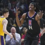 
              Los Angeles Clippers guard Terance Mann (14) reacts after making a 3-point basket during the first half of the team's NBA basketball game against the Los Angeles Lakers on Thursday, March 3, 2022, in Los Angeles. (AP Photo/Marcio Jose Sanchez)
            