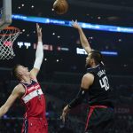 
              LA Clippers center Ivica Zubac (40) shoots against Washington Wizards center Kristaps Porzingis (6) during the first half of an NBA basketball game in Los Angeles, Wednesday, March 9, 2022. (AP Photo/Ashley Landis)
            