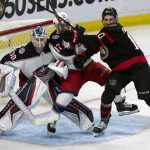 
              Ottawa Senators left wing Alex Formenton pushes Columbus Blue Jackets right wing Justin Danforth into Blue Jackets goaltender Elvis Merzlikins during the third period of an NHL hockey game Wednesday, March 16, 2022 in Ottawa, Ontario.(Adrian Wyld/The Canadian Press via AP)
            