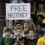 
              A student holds up a sign during an NCAA college basketball game against Iowa State, Saturday, March 5, 2022, in Waco, Texas. (Chris Jones/Waco Tribune-Herald via AP)
            