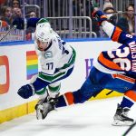 
              New York Islanders' Oliver Wahlstrom (26) checks Vancouver Canucks' Brad Hunt (77) during the second period of an NHL hockey game Thursday, March 3, 2022, in Elmont, N.Y. (AP Photo/Frank Franklin II)
            