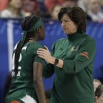 
              Miami head coach Katie Meier speaks with guard Ja'Leah Williams (12) during the first half of NCAA college basketball championship game against North Carolina State at the Atlantic Coast Conference women's tournament in Greensboro, N.C., Sunday, March 6, 2022. (AP Photo/Gerry Broome)
            
