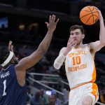 
              Tennessee forward John Fulkerson (10) passes over Longwood guard Isaiah Wilkins (1) during the second half of a college basketball game in the first round of the NCAA tournament in Indianapolis, Thursday, March 17, 2022. (AP Photo/Michael Conroy)
            