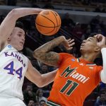 
              Kansas' Mitch Lightfoot and Miami's Jordan Miller go for a rebound during the second half of a college basketball game in the Elite 8 round of the NCAA tournament Sunday, March 27, 2022, in Chicago. (AP Photo/Nam Y. Huh)
            
