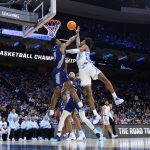 
              North Carolina's Leaky Black, right, goes up for a shot against St. Peter's Fousseyni Drame during the first half of a college basketball game in the Elite 8 round of the NCAA tournament, Sunday, March 27, 2022, in Philadelphia. (AP Photo/Matt Rourke)
            