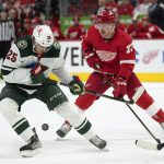 
              Minnesota Wild defenseman Jonas Brodin (25) and Detroit Red Wings left wing Adam Erne (73) battle for the puck in the first period of an NHL hockey game Thursday, March 10, 2022, in Detroit. (AP Photo/Paul Sancya)
            