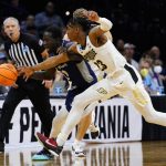 
              Saint Peter's Fousseyni Drame, center, and Purdue's Jaden Ivey chase after a loose ball during the second half of a college basketball game in the Sweet 16 round of the NCAA tournament, Friday, March 25, 2022, in Philadelphia. (AP Photo/Chris Szagola)
            