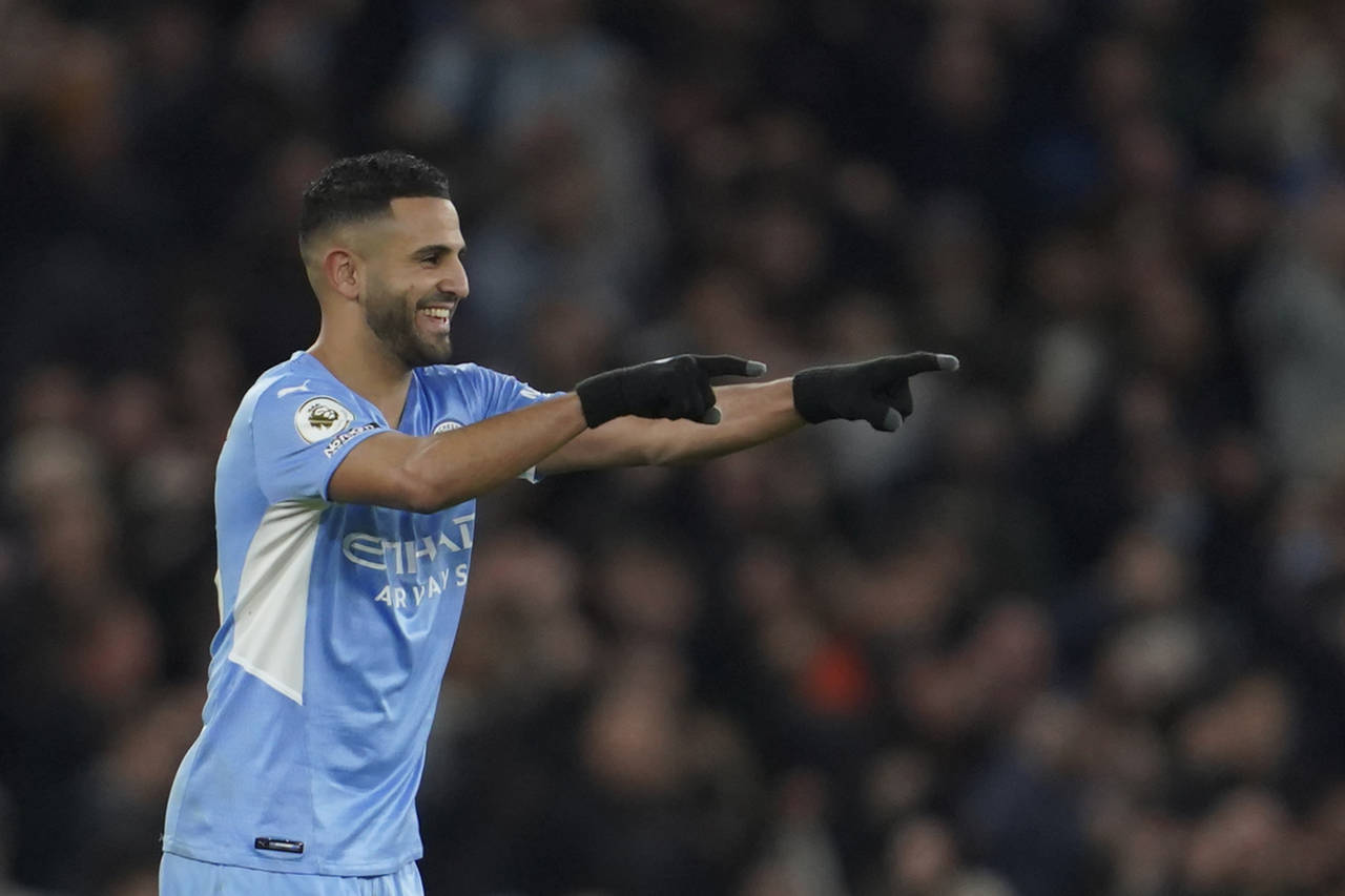 Manchester City's Riyad Mahrez celebrates after scoring his side's fourth goal during the English P...