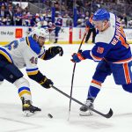 
              New York Islanders' Anthony Beauvillier (18) shoots the puck past St. Louis Blues' Jake Walman (46) during the second period of an NHL hockey game Saturday, March 5, 2022, in Elmont, N.Y. (AP Photo/Frank Franklin II)
            