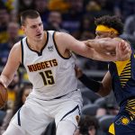 
              Denver Nuggets center Nikola Jokic (15) drives on Indiana Pacers forward Justin Anderson (10) during the second half of an NBA basketball game in Indianapolis, Wednesday, March 30, 2022. The Nuggets won 125-118. (AP Photo/Michael Conroy)
            