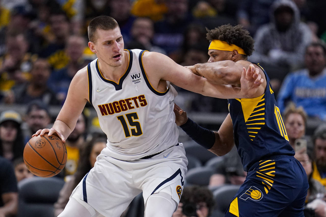 Denver Nuggets center Nikola Jokic (15) drives on Indiana Pacers forward Justin Anderson (10) durin...