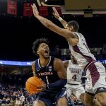 
              Virginia forward Jayden Gardner (1) is defended by Mississippi State players, including Garrison Brooks, right, and Cameron Matthews (4) during an NCAA college basketball game in the first round of the NIT, Wednesday, March 16, 2022, in Charlottesville, Va. (Erin Edgerton/The Daily Progress via AP)
            