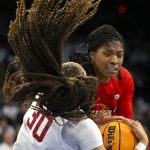 
              Utah forward Dasia Young (34) and Stanford guard Haley Jones (30) fight for control of the ball during the first half of an NCAA college basketball game for the Pac-12 tournament championship Sunday, March 6, 2022, in Las Vegas. (AP Photo/Ellen Schmidt)
            