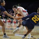 
              Utah's Isabel Palmer (1) drives into California's Cailyn Crocker (22) during the first half of an NCAA college basketball game in the first round of the Pac-12 women's tournament Wednesday, March 2, 2022, in Las Vegas. (AP Photo/John Locher)
            