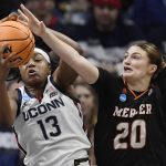 
              Connecticut's Christyn Williams (13) and Mercer's Sierra Votaw (20) reach for a rebound during the first half of a first-round women's college basketball game in the NCAA tournament, Saturday, March 19, 2022, in Storrs, Conn. (AP Photo/Jessica Hill)
            