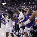 
              TCU guard Mike Miles (1), Eddie Lampkin (4) and the rest of the bench celebrate in the final seconds of the second half of an NCAA college basketball game against Kansas in Fort Worth, Texas, Tuesday, March 1, 2022. (AP Photo/Tony Gutierrez)
            