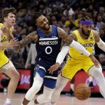 
              Minnesota Timberwolves guard D'Angelo Russell (0) is fouled by Los Angeles Lakers forward Carmelo Anthony (7) with Lakers guard Austin Reaves (15) also defending during the first half of an NBA basketball game Wednesday, March 16, 2022, in Minneapolis. (AP Photo/Andy Clayton-King)
            