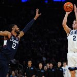 
              Villanova's Collin Gillespie (2) shoots over Connecticut's Tyler Polley (12) during the first half of an NCAA college basketball game in the semifinal round of the Big East conference tournament Friday, March 11, 2022, in New York. (AP Photo/Frank Franklin II)
            