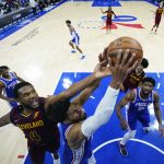 
              Philadelphia 76ers' Tobias Harris, center and Cleveland Cavaliers' Evan Mobley reach for a rebound during the second half of an NBA basketball game, Friday, March 4, 2022, in Philadelphia. (AP Photo/Matt Slocum)
            