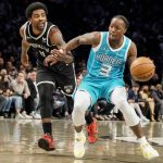 
              Charlotte Hornets guard Terry Rozier (3) drives against Brooklyn Nets guard Kyrie Irving (11) in the first half of an NBA basketball game, Sunday, March 27, 2022, in New York. (AP Photo/John Minchillo)
            