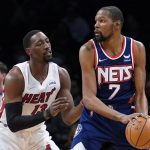 
              Brooklyn Nets forward Kevin Durant (7) looks to pass the ball as Miami Heat center Bam Adebayo (13) defends during the first half of an NBA basketball game Thursday, March 3, 2022, in New York. (AP Photo/John Minchillo)
            