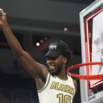 
              UAB guard Jordan Walker (10) holds up a piece of net after the team's win over Louisiana Tech in an NCAA college basketball game for the championship of the Conference USA men's tournament in Frisco, Texas, Saturday, March 12, 2022. UAB won 82-73. (AP Photo/LM Otero)
            