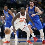 
              New York Knicks forward Julius Randle (30) losses his handle on the ball for a moment against Dallas Mavericks guard Luka Doncic (77) during the first half of an NBA basketball game in Dallas, Wednesday, March 9, 2022. (AP Photo/LM Otero)
            