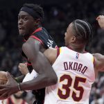 
              Toronto Raptors forward Pascal Siakam (43) tries to move the ball around Cleveland Cavaliers forward Isaac Okoro (35) during the first half of an NBA basketball game Thursday, March 24, 2022, in Toronto. (Nathan Denette/The Canadian Press via AP)
            