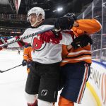 
              New Jersey Devils' Jimmy Vesey (16) checks Edmonton Oilers' Jesse Puljujarvi (13) during the first period of an NHL hockey game in Edmonton, Alberta, Saturday, March 19, 2022. (Jason Franson/The Canadian Press via AP)
            