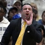 
              Bryant head coach Jared Grasso calls to his players during the first half of the Northeast Conference men's NCAA college basketball championship game against Wagner, Tuesday, March 8, 2022, in Smithfield, R.I. (AP Photo/Charles Krupa)
            