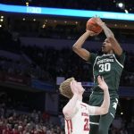 
              Michigan State's Marcus Bingham Jr. (30) shoots over Wisconsin's Steven Crowl (22) during the second half of an NCAA college basketball game at the Big Ten Conference men's tournament Friday, March 11, 2022, in Indianapolis. (AP Photo/Darron Cummings)
            