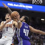 
              Phoenix Suns guard Devin Booker (1) is fouled by Sacramento Kings forward Trey Lyles (41) in the second half of an NBA basketball game in Sacramento, Calif., Sunday, March 20, 2022. The Suns won 127-124.(AP Photo/José Luis Villegas)
            