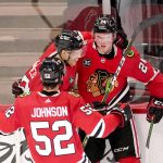 
              Chicago Blackhawks' Sam Lafferty (24) celebrates his goal with Caleb Jones, center, and Reese Johnson during the first period of an NHL hockey game against the Buffalo Sabres Monday, March 28, 2022, in Chicago. (AP Photo/Charles Rex Arbogast)
            