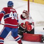 
              Montreal Canadiens' Joel Armia scores against Ottawa Senators goaltender Filip Gustavsson during the second period of an NHL hockey game Saturday, March 19, 2022, in Montreal. (Graham Hughes/The Canadian Press via AP)
            